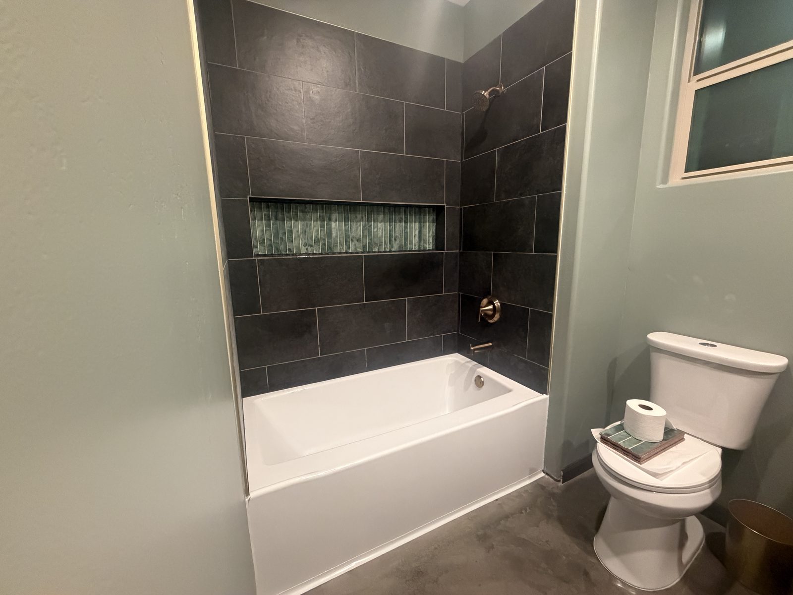 Finished bathroom with tiled tub surround